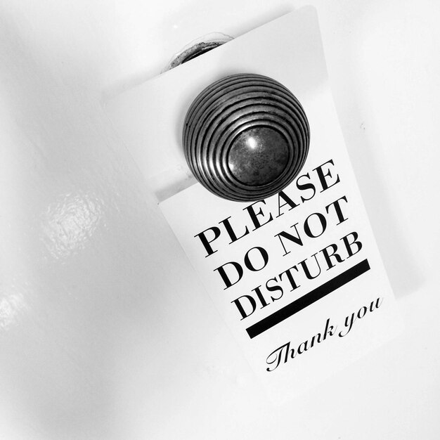 Photo close-up of information tag hanging on doorknob