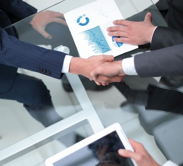 Close up investor and businessman shaking hands