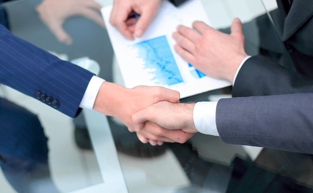 Close up investor and businessman shaking hands