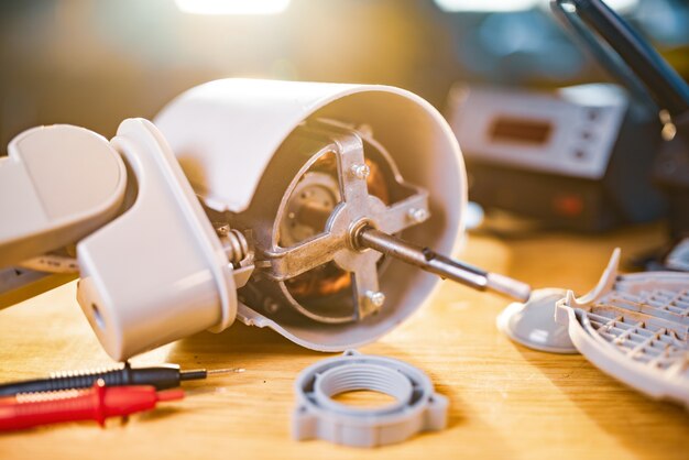 Close-up of iron motor from home cooling fan lies on a table