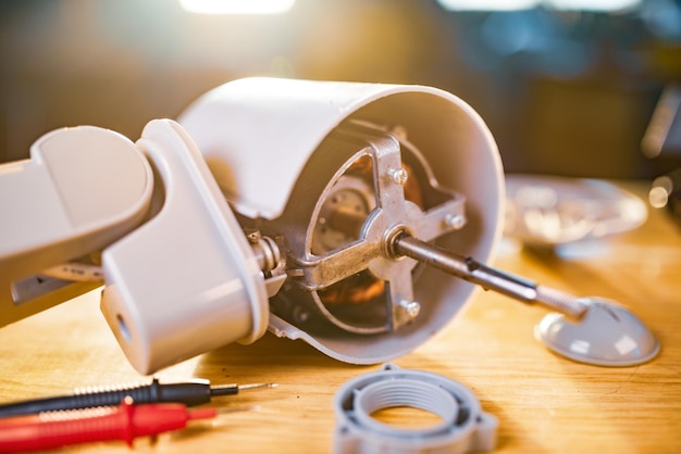 Photo close-up of iron motor from home cooling fan lies on a table