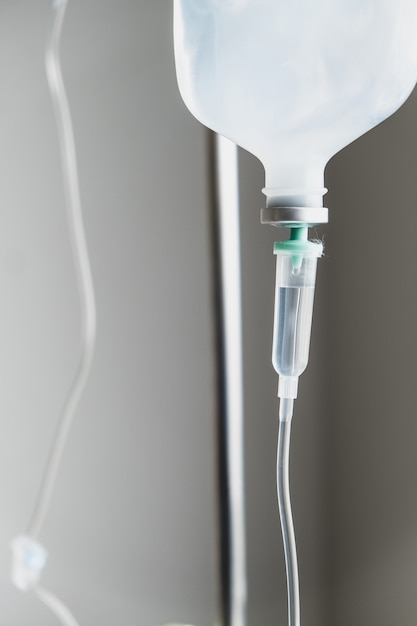 Photo close up of iv saline solution drip for patient in hospital