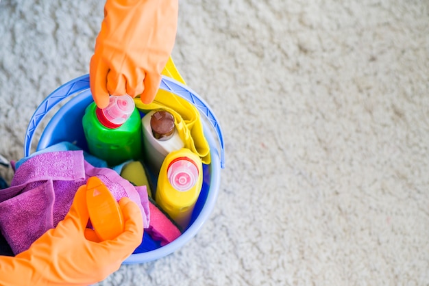 Close-up of janitor taking cleaning supplies from the bucket