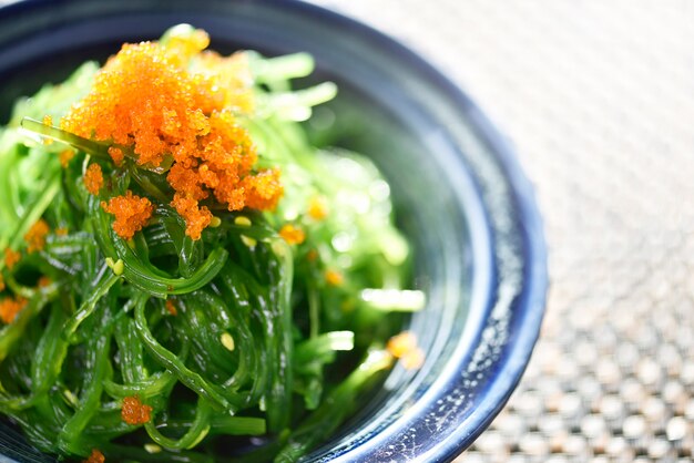 Photo close up japanese style seaweed salad, wakame salad, selective focus.