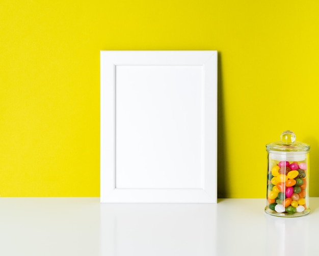 Close-up of jar on glass against yellow background