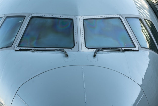 Close up of a jet airplane cockpit Front view of the airplane window with windshield wipers.