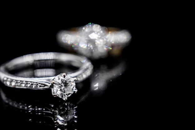 Close up Jewelry diamond ring on black background with reflection