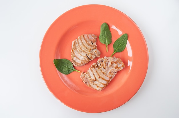 Close-up of a juicy delicious grilled tuna steak on a bright plate