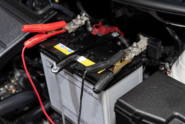 Photo close-up on jumper cables on car battery