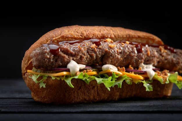 Close up of kebab sandwich on black wooden background