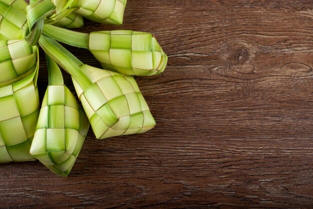 Close-up of ketupats on wooden table