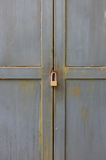 Close up key locked at metal door.