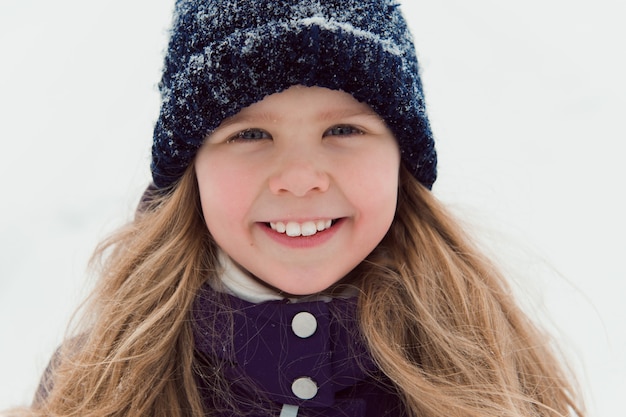 Close up kid face with snowflakes