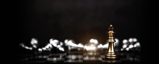 Close up king chess standing with falling chess on the back concept of team player or business team and leadership strategy and human resources organization management