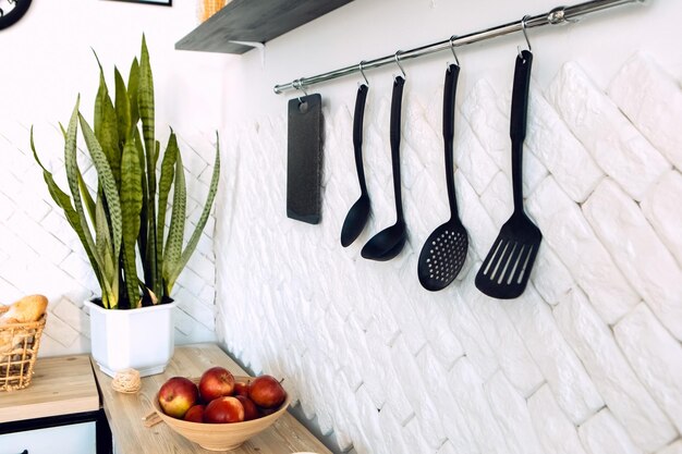 Close up kitchen supplies equipment, houseplant on the wooden table with kitchenware