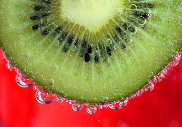 Close-up of kiwi in red drink