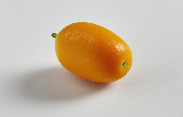 Close up of kumquat on grey background created using generative ai technology