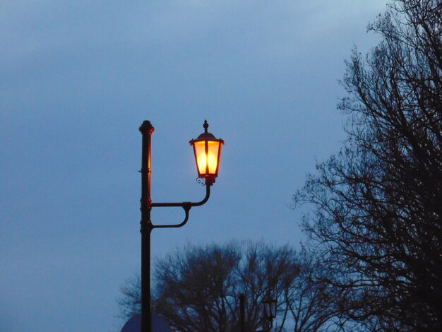 Close-up of lamp post against blue sky