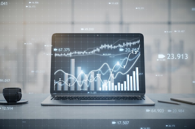 close up of laptop computer at workplace with coffee cup and candlestick forex chart or graph on blurry window with city view background financial trade market and stock concept 3d rendering