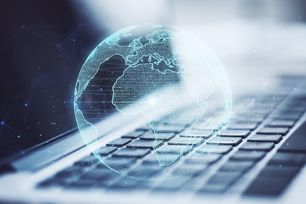 Close up of laptop and creative glowing polygonal grid planet on blurry background Globe international map communication network earth and technology concept Double exposure