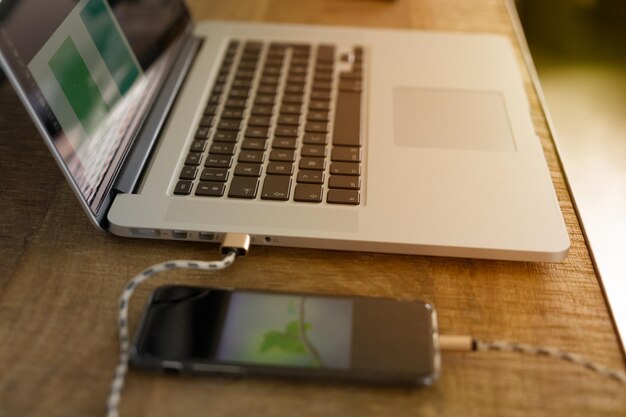 Close-up of laptop and mobile phone on table