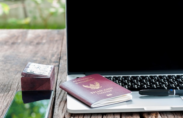 Photo close-up of laptop on table with passport