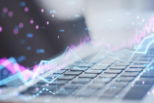 Close up of laptop with abstract glowing candlestick forex chart with index and grid on blurry background Invest trade finance ans stock market concept Double exposure