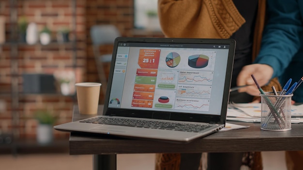 Close up of laptop with chart rate information on desk used by business people to plan project and design marketing strategy. Modern computer with research data analysis on display.