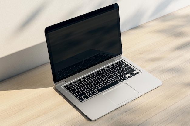 Close up of laptop with empty screen and reflections at wooden workplace with shadows 3D Rendering