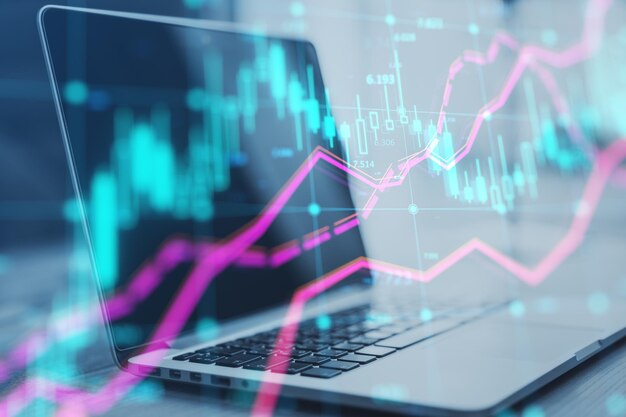 Close up of laptop at workplace with glowing forex index chart with grid on blurry background Market finance and online trading concept Double exposure