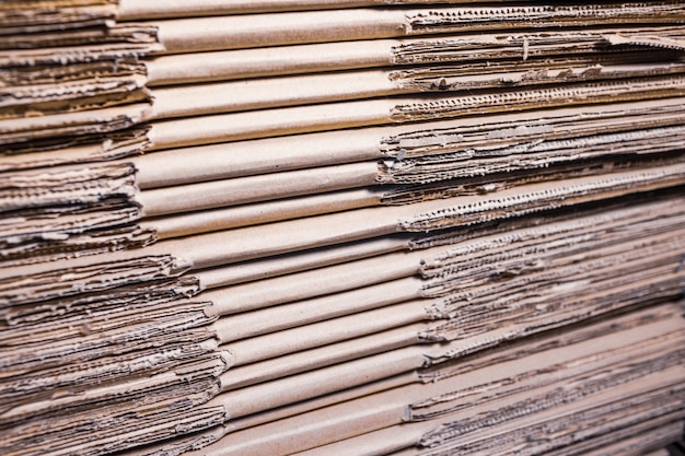 Close-up large cardboard piles lie on top