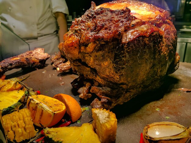Close-up of large roasted meat on table