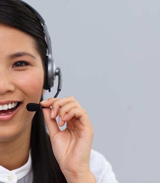 Close-up of a laughing customer service agent using headset 