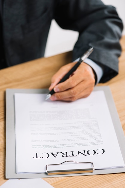 Photo close-up of lawyer's hand signing an official document