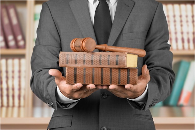 Close up lawyer with gavel judge and books