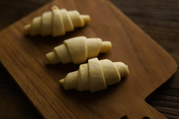 Close Up Layered of a Fluffy Leavened Uncooked Raw Traditional French Croissants Dough Roll.