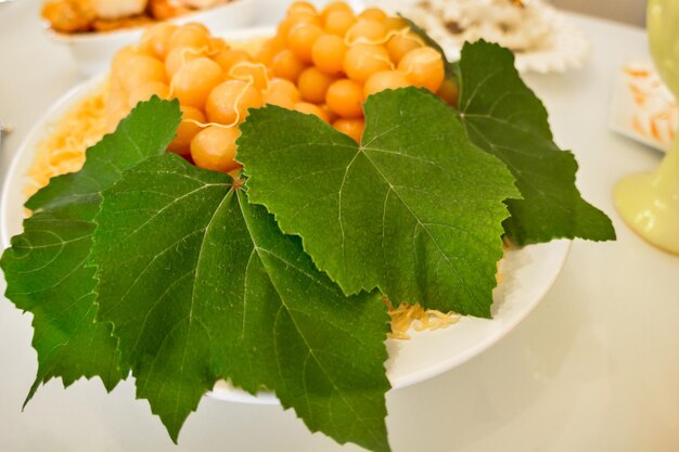 Close-up of leaf and sweet food in bowl