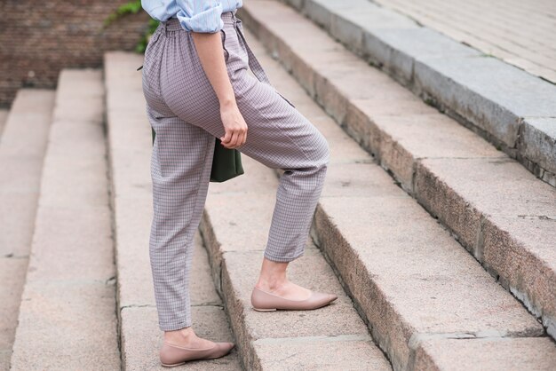 Close up of legs of business woman walking on steps. business\
concept.