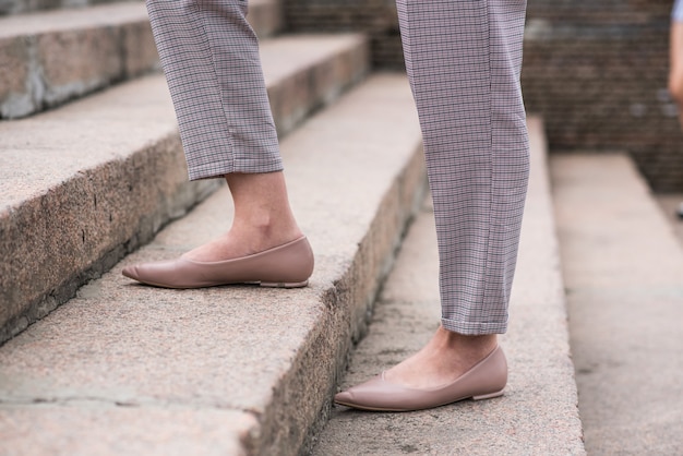 Close up of legs of business woman walking on steps. business\
concept.