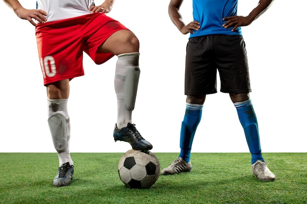 Close up legs of professional soccer, football players fighting\
for ball on field isolated on white background. concept of action,\
motion, high tensioned emotion during game. cropped image.