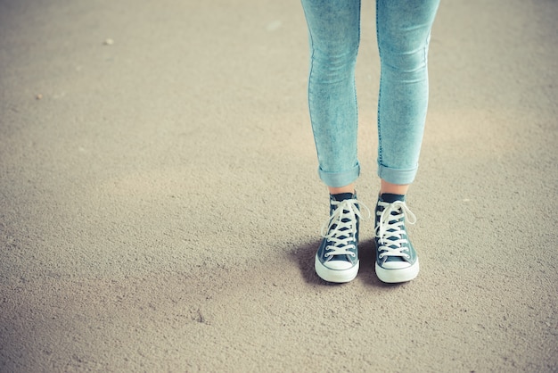 close up of legs woman with leggings and sneakers