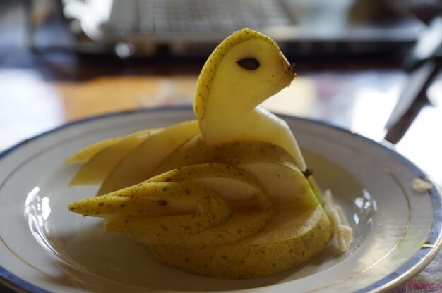 Close-up of lemon slice in plate on table