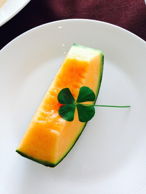 Close-up of lemon slice in plate on table