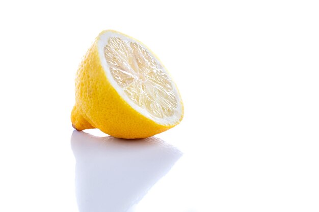 Close-up of lemon on table against white background