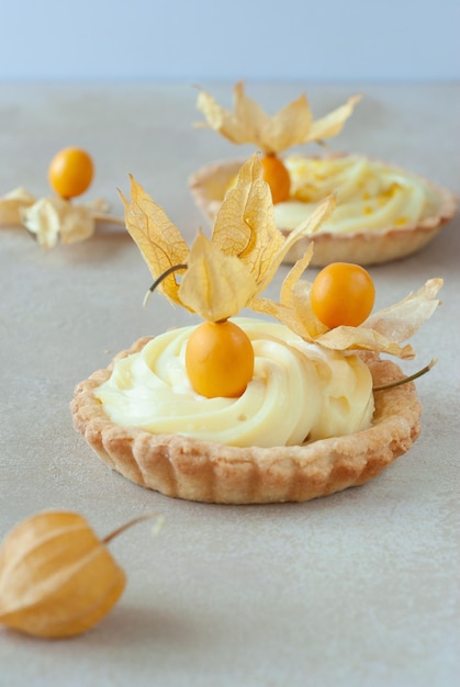 A close up of a lemon tart with yellow leaves on top