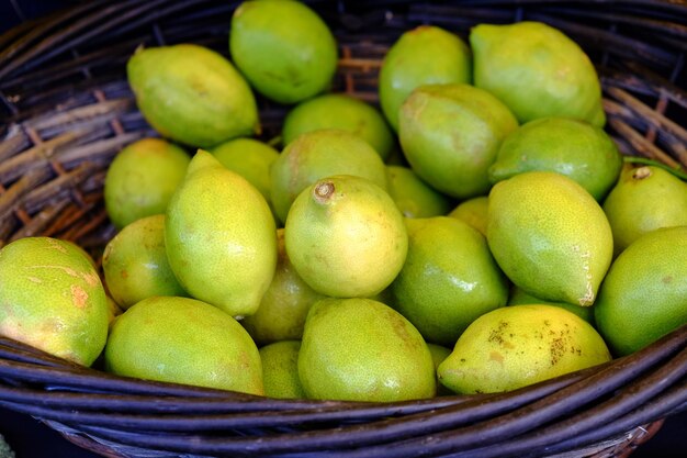 Close-up of lemons in basket at market for sale