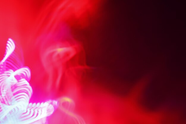 Photo close-up of light painting against red background