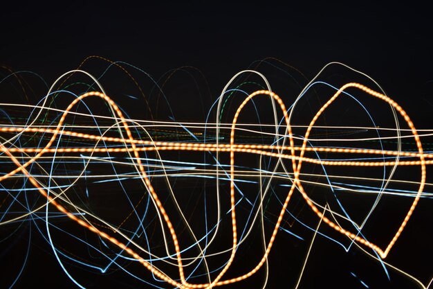 Photo close-up of light trails against clear sky at night