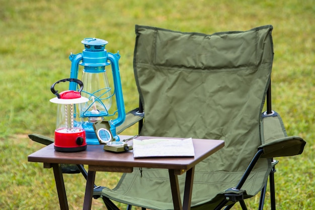 Photo close up of lighting equipment with navigation compass and map on table