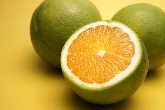 Close-up of limes against yellow background